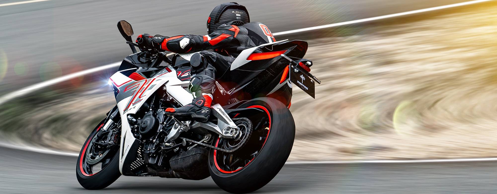 Zontes motos en Uruguay - Zontes 703RR avanzando con decision sobre la pista, con carenado envolvente y una postura claramente sport. Zontes motos en Uruguay - Zontes 703RR en marcha rapida con faro encendido, piloto inclinado y una silueta blanca con acentos rojos muy visibles.